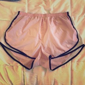 Pink and white nike running shorts